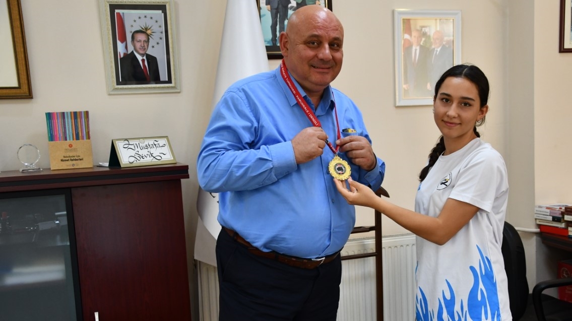 Madalyasını Başkan Şevik’e hediye etti